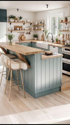 a kitchen with blue cabinets and wooden counter tops in the middle of it is surrounded by open shelving