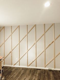 an unfinished room with wood paneling and white walls