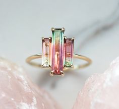 Three stone natural watermelon tourmaline ring. SOLD Similar can be made with other similar tourmalines. The design can be made with gemstones of your choosing. If you would prefer a custom ring, please contact us before purchase. Please take a look at our similar designs at the following links: https://www.etsy.com/listing/498675762/tourmaline-ring-diamond-engagement-ring https://www.etsy.com/listing/523459035/tourmaline-ring-diamond-engagement-ring Details; Main stone: bicolor watermelon tourm Watermelon Tourmaline Engagement Ring, Bijoux Art Deco, Pink Wedding Rings, Watermelon Tourmaline Ring, Tourmaline Engagement Ring, Baguette Engagement Ring, Ring Baguette, Ring Rosegold, Baguette Ring