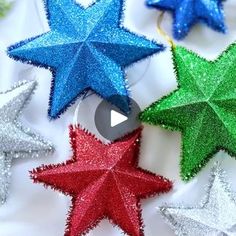 five stars are arranged in different colors on a white surface with the text, how to make glitter star ornaments