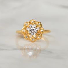 a gold ring with a flower design on it