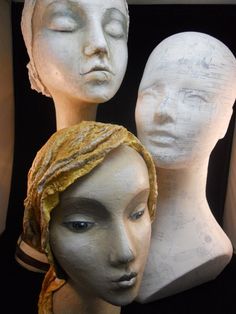 three mannequin heads with head scarves on them