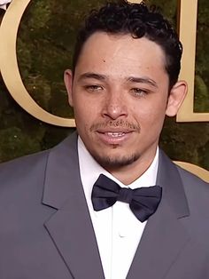 a man wearing a suit and bow tie