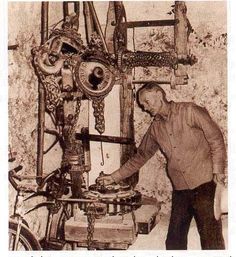 an old photo of a man working on a machine