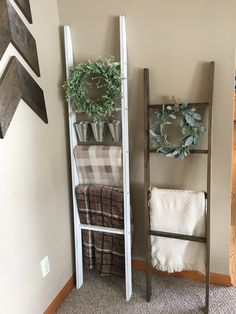 a ladder leaning up against the wall next to a towel rack with plants on it