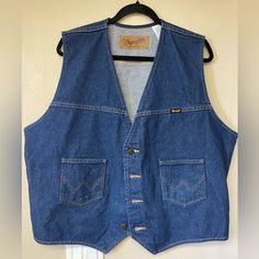 This Wrangler Vest Is In Perfect Condition Without Tags. Beautiful Dark Blue And Can Be Styled So Many Ways. Comes From A Pet Free And Smoke Free Home Western Denim Outerwear With Pockets, Western Style Medium Wash Cotton Outerwear, Western-style Medium Wash Cotton Outerwear, Cotton Denim Jacket With Pockets For Rodeo, Western Style Cotton Outerwear In Medium Wash, Western Denim Vest For Fall, Vintage Cotton Denim Jacket For Rodeo, Vintage Medium Wash Denim Jacket For Rodeo, Tan Denim Jacket