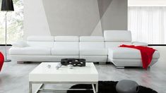 a modern living room with white leather furniture