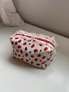 A strawberry shortcake pouch with a beige strawberry print on the outside and a red polka dot print on the inside. It includes some beige lace, a red zipper, and some beige bias tape on the inside of the pouch. Green Bay Packers Shirts, Strawberry Print, Bias Tape, Red Polka Dot, Toiletry Storage, Make Up Bag, The Pouch, Polka Dot Print, Strawberry Shortcake