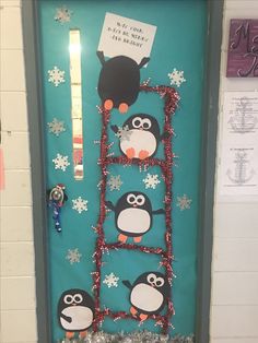 a door decorated with penguins and snowflakes