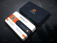 two business cards with q on the front and one in orange, white and black