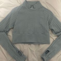 Color: Chalk Blue Size: S (Small) Mock Turtleneck(Doesn’t Go All The Way Up Your Neck) Comes With Thumbholes On Both Sleeves Cropped Fit Hits At Waist Never Worn, No Tags Blue Ribbed Athleisure Tops, Winter Light Blue Ribbed Top, Alo Yoga Long Sleeve Tops For Fall, Long Sleeve Alo Yoga Tops For Fall, Alo Yoga Long Sleeve Workout Tops, Seamless Alo Yoga Tops, Blue High Stretch Casual Crop Top, Alo Yoga Tops For Fall Layering, Alo Yoga Long Sleeve Winter Top