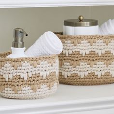 two woven baskets with soap dispensers on top of a white countertop