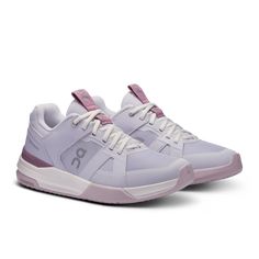 a women's tennis shoe in white and pink