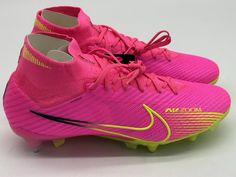 a pair of pink and yellow nike soccer cleats