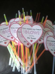 valentine's day candy sticks are arranged in the shape of hearts with messages on them