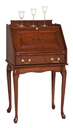 an old fashioned wooden desk with three glasses on it's top and bottom shelf