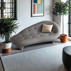 a living room filled with furniture and plants