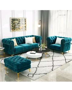 a living room filled with blue couches and white rugs on top of a hard wood floor