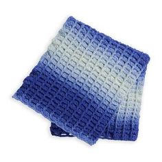 two blue and white crocheted dishcloths sitting on top of each other