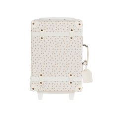 a white suitcase with gold dots on the front and side, sitting against a white background