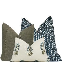 three pillows with blue and white designs on them