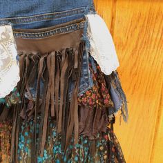 "Handmade Repurposed Wrap Skirt Perfect for summer festivals A combination of mixed textiles including denim, floral print fabric, lace, and brown fringe. No visible signs of wear and tear. Measurements (taken laying flat on front side): Waiste: 31\" Length from waiste: 17 1/2\" Send us a message with any questions! JMM" Bohemian Bottoms With Frayed Hem For Festivals, Bohemian Festival Bottoms With Frayed Hem, Bohemian Brown Bottoms With Fringe, Bohemian Brown Fringe Bottoms, Bohemian Cotton Skirt With Frayed Hem, Bohemian Cotton Bottoms With Fringe, Bohemian Cotton Fringe Bottoms, Upcycled Bohemian Bottoms For Festival, Bohemian Upcycled Bottoms For Festival