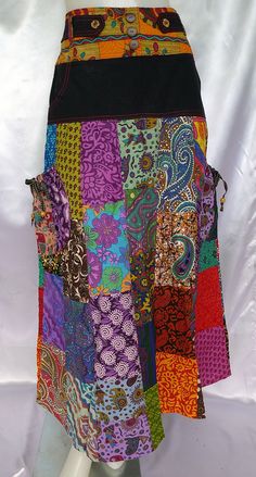 A great long stylish skirt that's vibrant and colourful with patchwork all round. Very Unique, Funky and Boho looking, with beautiful workmanship, great detail and adjustable sizing. Great for every day casual wear, festivals and other occasions.  The patchwork is a mixed variety of patterned quality cotton prints and colours. This design includes ties on each side pocket, coconut shell buttons including carved flowers, painted wooden beads, and elastic hemmed pockets. The shirred/smocked waist at back gives it easy flexible sizing and a very comfortable fit. Measurements: Waist: 26 - 34 inches at full stretch (66-86 cm) Hips: 38 inches (96.5 cm) Length: 39 inches (99 cm) Please note: Our products may be different to the sizing standard of your country. Please check size measurements liste Hippie Multicolor Patchwork Maxi Skirt, Hippie Patchwork Multicolor Maxi Skirt, Hippie Multicolor Maxi Skirt With Patchwork, Multicolor Patchwork Maxi Skirt For Festivals, Hippie Long Patchwork Skirt, Hippie Long Skirt With Patchwork, Casual Multicolor Floral Patchwork Skirt, Green Patchwork Skirt For Festivals, Multicolor Harem Skirt For Festival