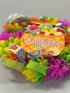 a close up of a bunch of colorful hair clips on a white surface with the words summer vibes written on it