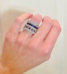 a woman's hand holding two different rings