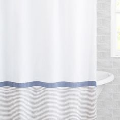 a white shower curtain with blue and gray stripes