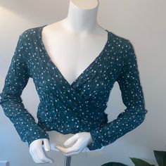 Nwt Brandy Melville Green Floral Wrap Top One Size Excellent Pre Owned Condition No Flaws One Size 100% Viscose Pit To Pit 15” Pit To Hem 8” Shoulder To Shoulder 17” Shoulder To Hem 16” Smoke Free Pet Free Home Offers Welcome Blue Wrap Tops For Fall, Fitted Floral Print Wrap Top, Casual Blue Wrap Top, Brandy Melville Sweatshirt, Brandy Melville Hoodie, Brandy Melville Shirts, Band Tank Tops, Floral Wrap Top, New York Sweatshirt