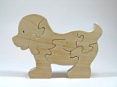 a wooden toy elephant with two pieces missing from it's body, standing on a white surface