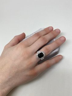 Start a conversation with this show stopping Art Deco inspired ring. A show stopping 4.22 ct black Spinel is the centerpiece of this creation, surrounded by a combination of 1.6 ct VS quality round, pear, and tapered baguette shaped diamonds. Inspired by the Art Deco period, we have created both contrast and symmetry with the depth of black hue from the Spinel and the contrast of the scintillating symmetrical diamonds that surround it. A collector piece sure to be an heirloom for many generation Timeless Black Jewelry With Center Stone, Elegant Evening Rings With Center Stone, Formal Black Round Cut Rings, Classic Black Baguette Cut Rings, Luxury Cluster Ring With Round Cut Gemstone, Luxury Evening Rings With Gemstone, Elegant Black Ring With Center Stone, Elegant Black Spinel Ring For Formal Occasions, Black Oval Jewelry With Brilliant Cut