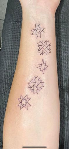 a woman's arm with three stars on it