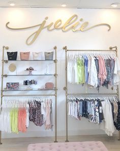 a clothing store with clothes on racks and hangings in front of the sign that says jellie