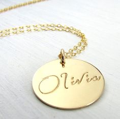 Gold Name Necklace  Gold Script Font Name Charm by ERiaDesigns Customizable Gold Name Necklace With Round Pendant, Gold Name Necklace With Round Pendant For Personalized Gift, Gold Round Pendant Name Necklace As Personalized Gift, Gold Round Pendant Name Necklace For Personalized Gift, Customizable Yellow Gold Round Name Necklace, Customizable Round Yellow Gold Name Necklace, Gold Name Disc Jewelry, Gold Hand Stamped Nameplate Necklace, Gold Round Disc Jewelry With Name