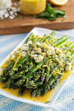 asparagus with lemon sauce on a white plate