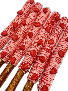 some strawberries are arranged in rows on sticks