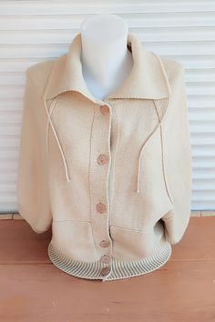 Vintage beige cardigan. Wool sweater .Pullover women's knitwear. Beige jacket with buttons, two pockets, high collar. Raglan sleeve 3/4 length. Back length - 20,47" or 52 cm. Distance from armhole to armhole -  18,89" or 48 cm. Good vintage condition. Care instructions: hand wash in cold water with mild soap, lay flat to dry.                                                                                                                                  Ready to ship. Beige Button-up Cardigan With Pockets, Cream Button-up Winter Sweater, Cream Sweater Coat With Button Closure And Long Sleeves, Cream Sweater Coat With Button Closure, Collared Winter Sweater With Pockets, Cream Button-up Winter Top, Cream Sweater With Button Closure For Winter, Beige Button-up Fall Sweater, Cream Long Sleeve Sweater Coat With Buttons