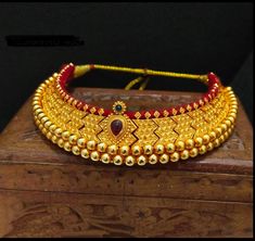 Vajratik jewellery is a traditional jewellery that is made by closely placing golden balls filled with wax to form sturdy jewellery. It has become famous all over India because of its lightweight and budget-friendly price point. This beautiful ornament is completely handmade which reflect Marathi karagiri. The necklace has adjustable thread attached. Vajratik Necklace, Traditional Adjustable Gold Kundan Necklace, Gold Kundan Choker For Rituals, Adjustable Gold Kundan Necklace In Temple Jewelry Style, Gold Meenakari Bridal Necklace With Round Beads, Gold Cutdana Bridal Necklace For Rituals, Gold Bridal Necklace With Cutdana For Rituals, Festive Temple Jewelry Choker For Puja, Gold Bridal Necklace With Cutdana Beads