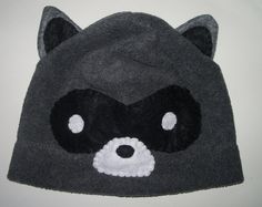 a black hat with a raccoon face on it