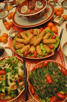 plates with food on them sitting on a table next to oranges and other foods