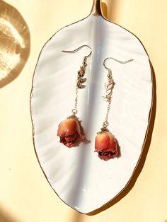 This pair of dainty earrings are made with real dried rose, covered in resin, and 14k gold-filled cable chain. The total length of this pair of earrings is around 3 inches. The rose is around 1 inch (diameter), and 1 inch tall. The roses vary slightly for each pair of earrings.  Please let us know if you have any questions!  BZB Gems Rose Color Drop Earrings As Gift, Rose Colored Drop Earrings As Gift, Rose Drop Earrings As A Gift, Rose Drop Earrings For Gifts, Rose Colored Drop Earrings For Gifts, Rose Dangle Jewelry For Gift, Rose Gold Flower-shaped Single Earring, Rose Gold Dangle Flower Earrings, Rose Gold Single Flower Earring