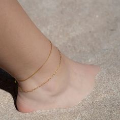 "Nothing quite matches its elegant simplicity. Its delicate cube links give this chain a smooth, even appearance.  A stunning vibe -- this chain feels good on the skin, it is lightweight yet very durable and perfect for everyday wear.  But don't stop there. You can spice it up by stacking gold and silver anklets together or with one of our other designs.   Material: 18k gold vermeil Chain type : Box chain Chain length (adjustable): 8.5\" + 1.5\" extension  --- CRAFTMANSHIP --- It is meticulously crafted using exceptional quality 18k gold vermeil. Gold vermeil is not to be confused with gold plating. It is significantly more durable. But not all gold vermeil is equal. At Jolie Co we apply a thick 3-micron layer of 18k gold onto 925 sterling silver. In addition, a heavy metal free and invisi Minimalist Gold Chain Anklets, Minimalist Gold Chain Anklets As Gift, Minimalist Gold Anklet With Adjustable Chain, Minimalist Adjustable Chain Anklet, Minimalist Gold Anklets For Everyday, Casual Gold Minimalist Anklets, Everyday Minimalist Gold Anklets, Subtle Beauty, Navel Jewelry