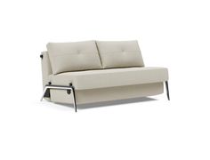 a white couch sitting on top of a white floor next to a metal leg rest