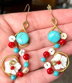 "Beautiful and very feminine handmade earrings for pierced ears.   These beauties feature a swirl base of gold metal decorated with chunks and beads of Turquoise, beads of red Coral, slices of mother of pearl and the main feature: pretty flowers made of mother of pearl.  The earrings are about 2 3/4\" and are one of a kind! Please look at the photos as they are a part of the description. I try my best to capture each and every item I have and to describe it as best I can. I ask you to look at th Unique Red Wire-wrapped Earrings, Unique Red Wire Wrapped Earrings, Bohemian Gold Flower Earrings For Beach, Bohemian Gold Flower Bead Earrings, Bohemian Wire Wrapped Flower Earrings, Unique Wire Wrapped Beaded Earrings, Bohemian Gold Flower Earrings With Round Beads, Bohemian Wire-wrapped Flower Earrings, Bohemian Wire Wrapped Flower Earrings For Gift