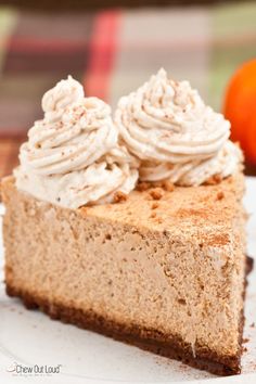 a piece of pumpkin cheesecake on a plate with a fork and knife next to it