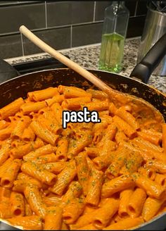 a pan filled with pasta sitting on top of a stove