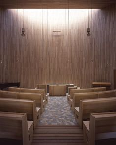 the inside of a church with wooden pews