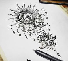 a drawing of a sunflower on top of a white paper next to a pen